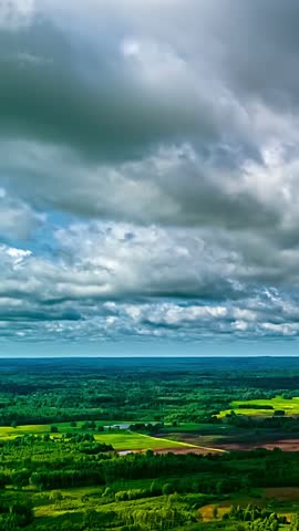 Rural countryside landscape under a dramatic sky with heavy moving clouds timelapse