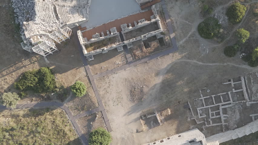D-Log M. Gelemis, Turkey. Top down aerial view of Patara Ancient Theatre, cavea with 38 rows and stage building, archaeological site of Lycian capital city. Aerial View, HEAD OVER SHOT with rotation, MasterShots