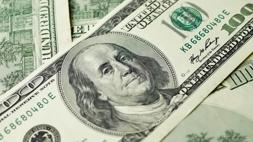 Detailed close up of 100 dollar bill, highlighting Benjamin Franklins portrait. Paper money defined by government regulations. Legal tender for settling national and international debts