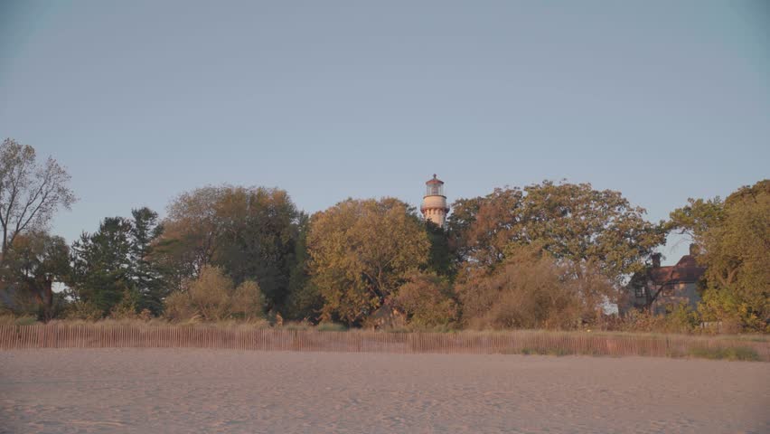 Wide Shot of Grosse Point Lighthouse Rising Above Trees on Evanston Beach, Illinois