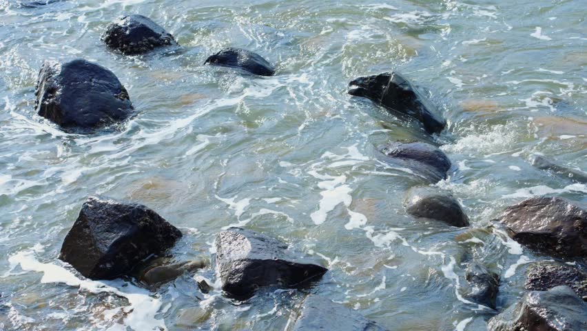 Ocean waves hitting rocky shore