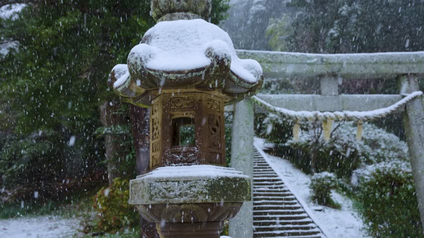 Stone Lantern and Snowy Torii Gate on Shimane Oki Islands, Japan in Winter