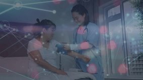 Animation of network of connections over asian female doctor treating patient. Global medicine and digital interface concept digitally generated video. - Powered by Shutterstock - Get 15% off with code: PIKWIZARD15