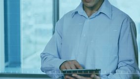 Animation of data processing and diagrams over asian businessman using tablet in office. Technology, business and digital interface concept digitally generated video. - Powered by Shutterstock - Get 15% off with code: PIKWIZARD15