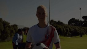 Holding ball with financial data graph overlay, soccer player on field. Sports, business, finance, investment, teamwork, strategy - Powered by Shutterstock - Get 15% off with code: PIKWIZARD15