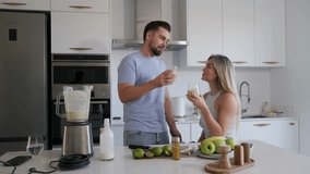 Couple Enjoying Homemade Smoothie Together in Modern Kitchen - Powered by Shutterstock - Get 15% off with code: PIKWIZARD15