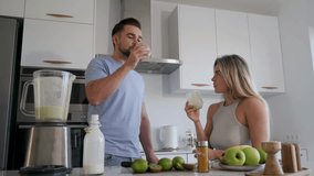 Couple Enjoying Homemade Smoothie Together in Modern Kitchen - Powered by Shutterstock - Get 15% off with code: PIKWIZARD15