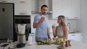 Couple Enjoying Homemade Smoothie Together in Modern Kitchen - Powered by Shutterstock - Get 15% off with code: PIKWIZARD15