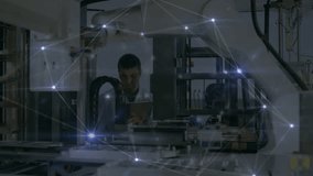 Engineer using tablet inspecting robotic cell, displaying glowing network overlay on control panels. Automation, manufacturing, connectivity, technology, industry, innovation, robotics - Powered by Shutterstock - Get 15% off with code: PIKWIZARD15