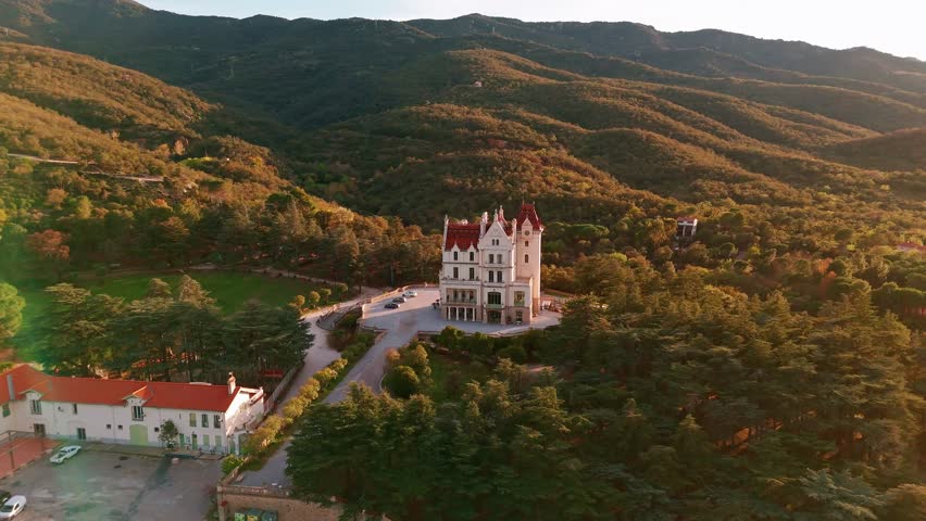 Aerial view of a chateau with vineyards at sunset in the spring season in France