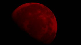 A stunning blood moon during a total lunar eclipse, appearing a deep red or orange hue. - Powered by Shutterstock - Get 15% off with code: PIKWIZARD15