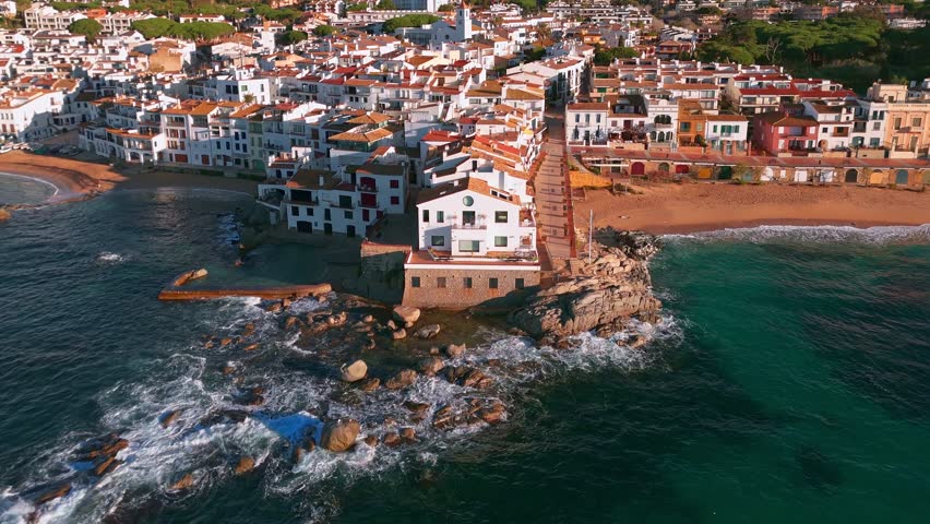 Aerial view of the charming village of Calella de Palafrugell at sunrise in Catalonia, Costa Brava, Spain. Scenic coastal townscape with traditional architecture and tranquil morning light.