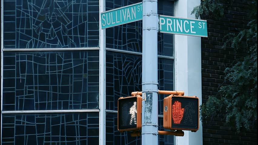 Street-level footage from 2013 showing Prince Street and Sullivan Street intersection in SoHo, New York, with iconic street signage
