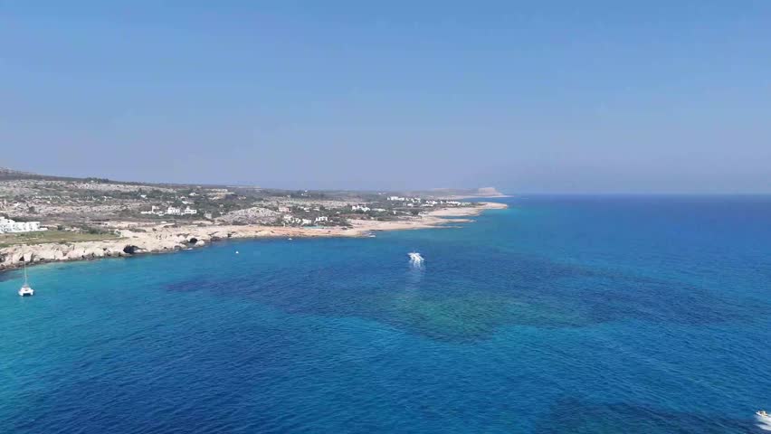Stunning coastal landscape of Cyprus featuring white sand beaches and volcanic rock formations