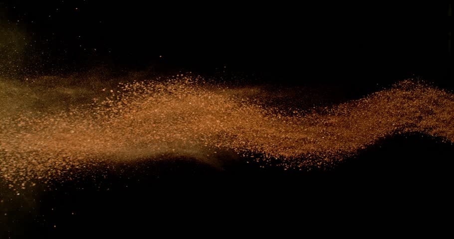 Flying Orange Clay Powder. Abstract Linear Dust Flow in Super Slow Motion. 1000fps. Isolated on Black Background. Tennis Themed Design Element for Dynamic Visuals
