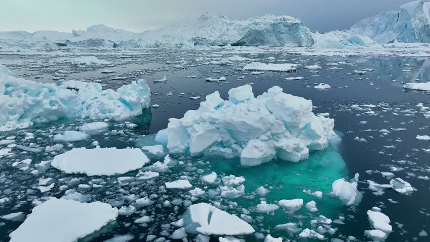 Aerial view of icebergs near Greenland coast, Arctic landscape, melting ice and climate change concept, polar region nature, 4K footage
