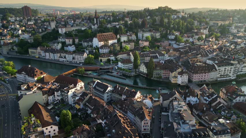Chapel Bridge and Water Tower in Lucerne, Switzerland, old town architecture over Reuss River, European cultural landmark and popular travel destination. Aerial View