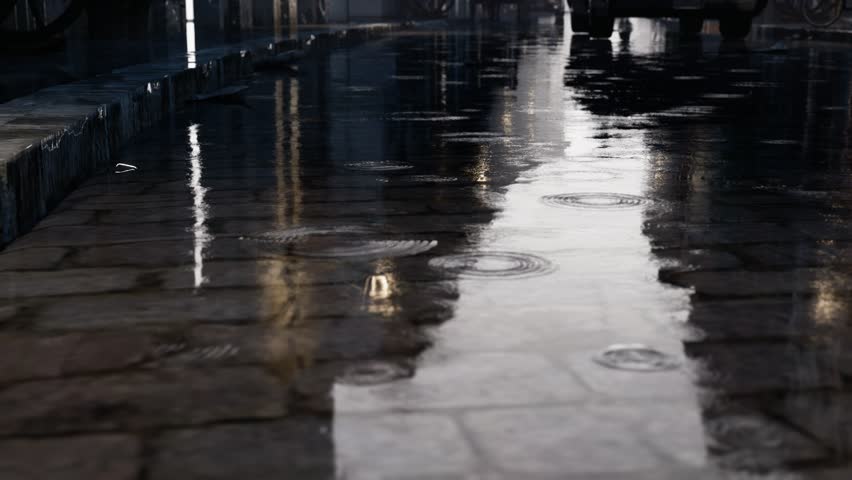 Detailed 4k shot of rain in puddle on a wet urban street surface, showing ripples and reflections. Perfect for weather, cityscape, and nature themes.