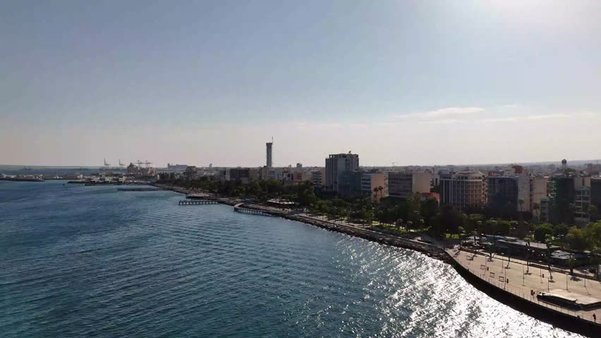 Drone perspective from the sea looking towards the bustling city of Limassol and its long promenade
