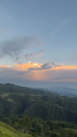 A breathtaking view from a high hill showcasing lush landscapes and rolling hills. Expansive skies and vibrant greenery create a serene and immersive natural panorama.