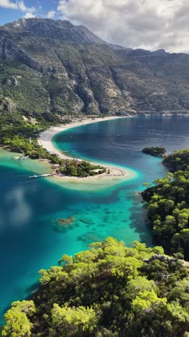 Iconic Oludeniz Blue Lagoon in Turkey, crystal clear turquoise water, sandy beach and mountain landscape forming famous Mediterranean resort destination, Aerial View