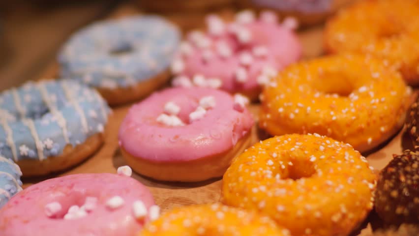 A close-up of delicious donuts with colorful icing.