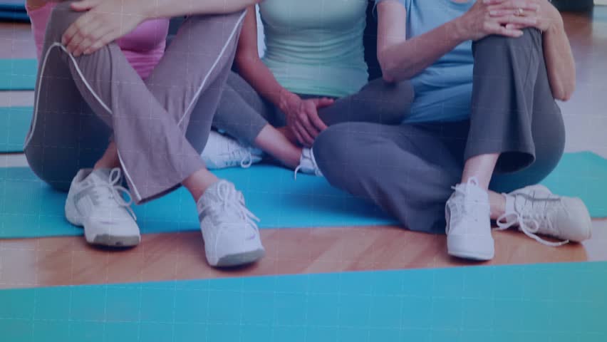Camera revealing five women posing on mats in gym studio, equalizer pulsing across faces for promo. Group, class, workout, fitness, female, camaraderie, energy