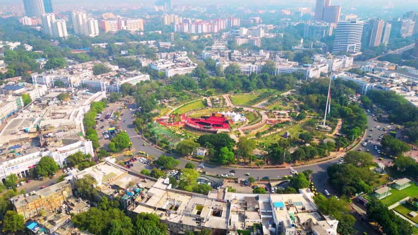 Aerial view of Connaught Place in New Delhi, India, showcasing the central business district with radial roads, urban transportation, high-angle buildings, and cityscape patterns. Iconic commercial hub highlighting modern city life and infrastructure.