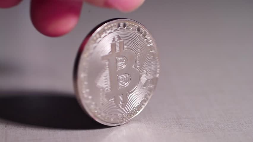 The Bitcoin coins were spinning slowly on the table