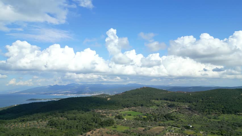 Aerial Drone View Of Green Hills And Coastline Under Dramatic Clouds