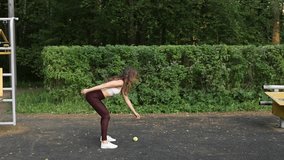 caucasian woman coordination drill tossing ball at park - Powered by Shutterstock - Get 15% off with code: PIKWIZARD15