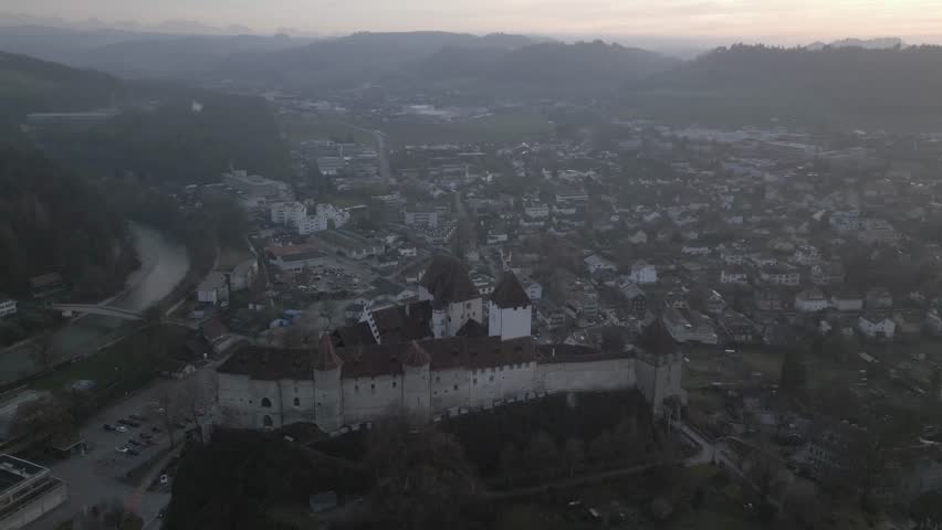 Aerial drone footage showcasing Burgdorf Castle and the surrounding town in Switzerland under clear daylight conditions.