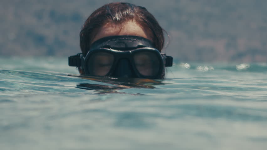 Close up portrait of the woman freediver swimming with mask underwater and exploring the tropical sea in Indonesia