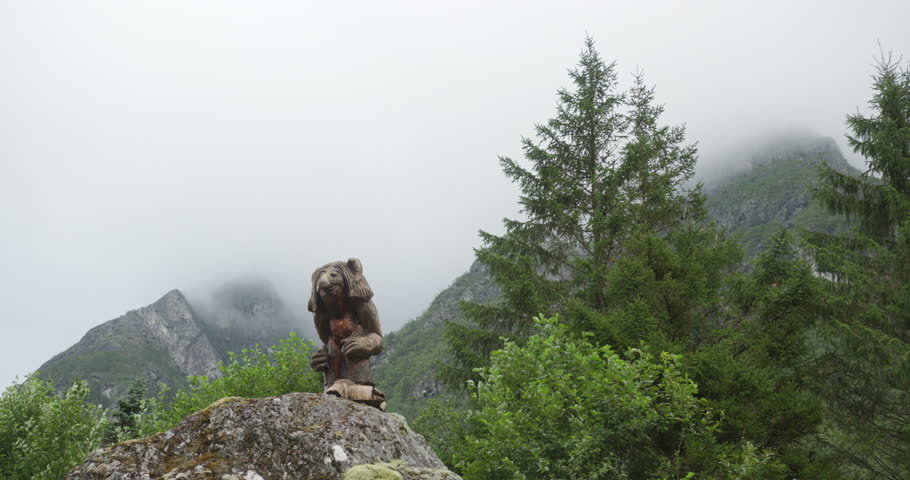 Norwegian troll sculpture standing in a misty mountain landscape