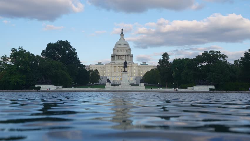 Capitol building symmetry and reflection. Washington DC travel destination landmark. United States Capitol exterior panorama. Washington DC building landscape. Capitol Hill Washington DC skyline.