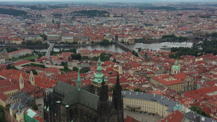 Prague Old Town in Czech Republic with Famous Sightseeing Places in Background. Charles Bridge Iconic 14th century Structure with View, Vltava river and Prague Cityscape. Must Visit City. Drone, 4k