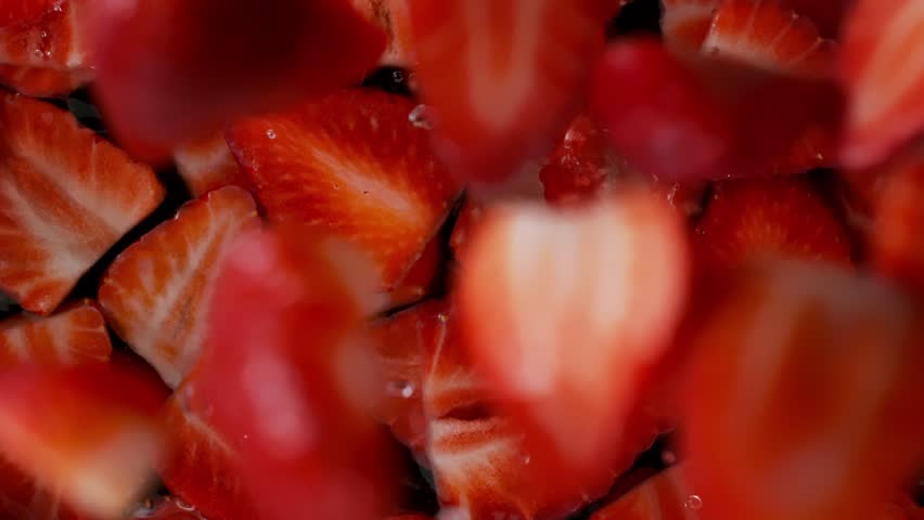 Super Slow Motion Shot of Fresh Strawberries Falling into Water at 1000fps.