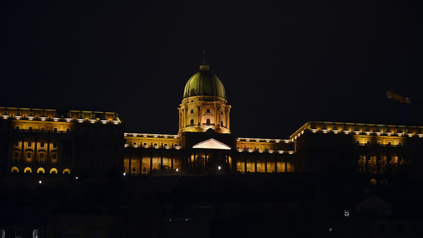 Illuminated Buda Castle complex overlooking the Danube River at night in Budapest, Hungary