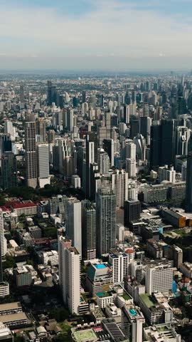 Modern city view showcasing skyscrapers, green spaces, and developed urban areas. Bangkok, Thailand.