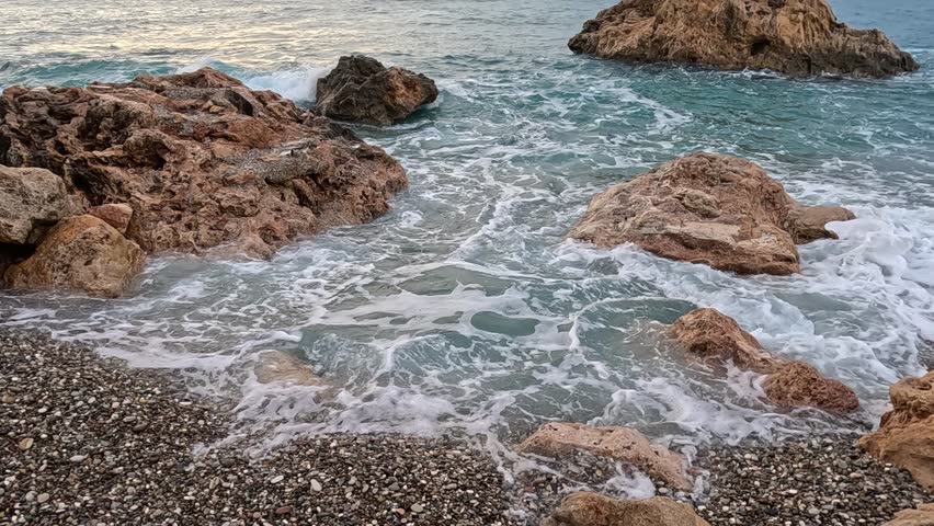 sea waves crashing on rocks