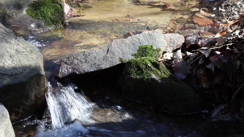 small waterfall stream with moss