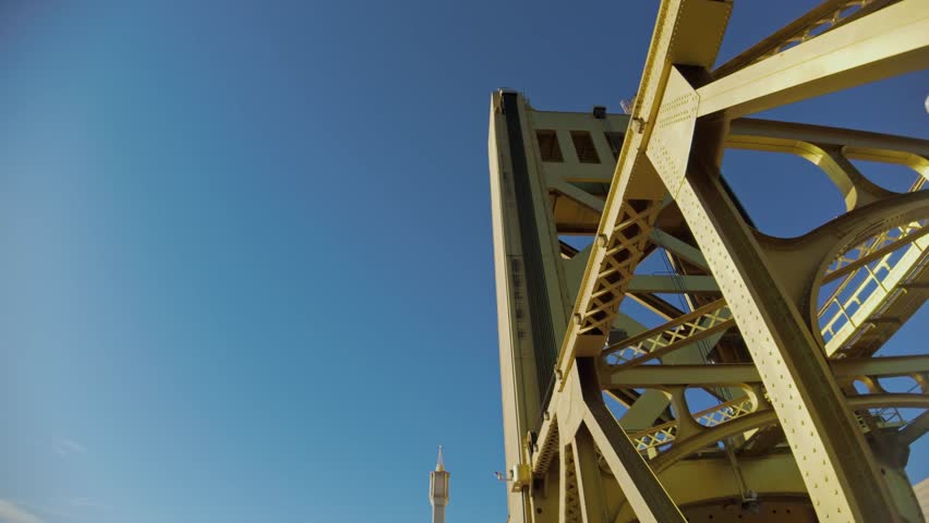view of the iconic golden Tower Bridge against a clear blue Sacramento sky