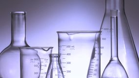 Pouring chemicals into lab glassware