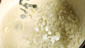 Chopped White Onions Falling Into A Hot Pot Of Sizzling Oil In Top Down Close Up Cooking Scene - Powered by Shutterstock - Get 15% off with code: PIKWIZARD15