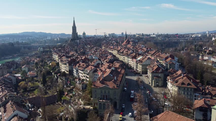Bern, Switzerland: Aerial drone footage of the cobblestone streets of Bern medieval old town leading to the Berne cathedral in Switzerland capital city. 