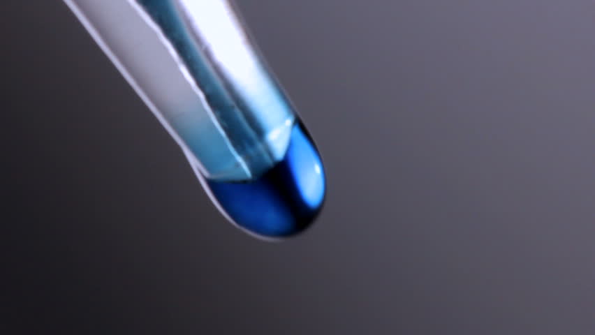 Close up of liquid dripping from a pipette, shot in HD video
