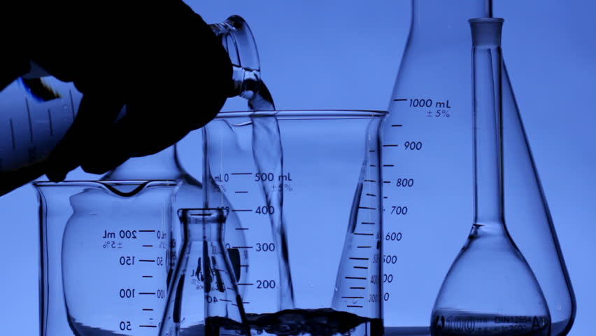 Close up HD video of scientist pouring chemical into flask, shot in HD video