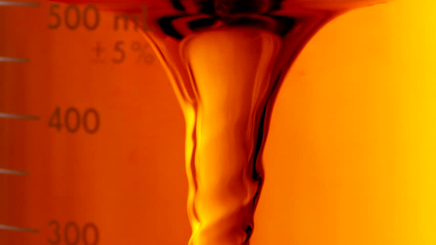 Extreme close up of biofuel mixing in laboratory beaker, shot in HD video