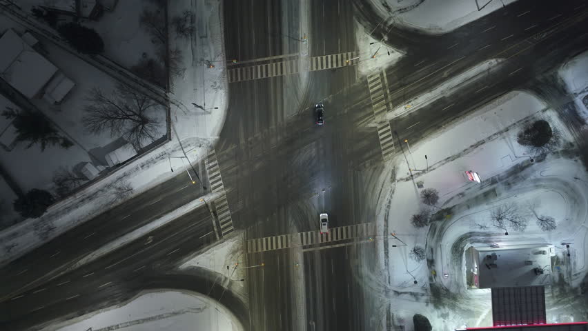 Snowy night urban intersection, aerial view in Mississauga, Canada