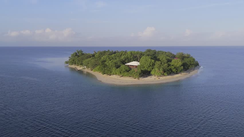 Island in the middle of deep blue ocean